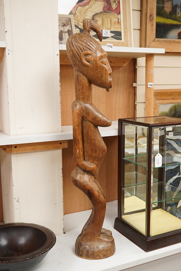 A Fijian carved wood Kava bowl and a West African Dogon fertility figure, 91cm tall